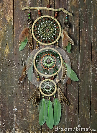 Beautiful handmade boho dreamcatcher with green feathers and beads Stock Photo