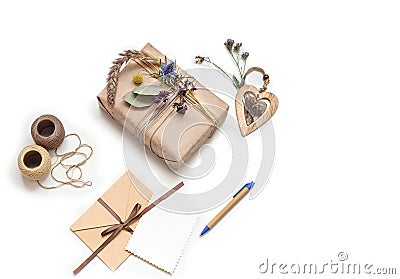 Beautiful handmade gift box (package) with flowers, envelope on white background. Stock Photo