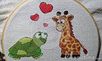 Beautiful handmade turtle and giraffe embroidery Stock Photo