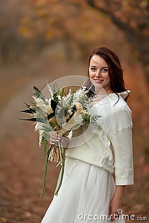 beautiful happy bride holding wedding autumn bouquet Stock Photo