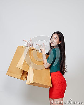 Happy Christmas Asian woman shopping holding paper bags Stock Photo