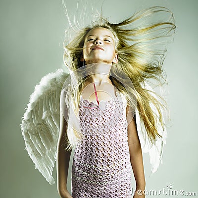 Beautiful happy girl with angel wings Stock Photo