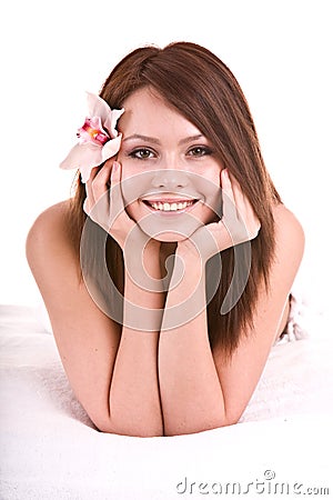 Beautiful happy girl with flower in bed. Stock Photo