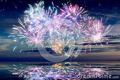 Beautiful happy new year fireworks in the sky with reflections on water Stock Photo