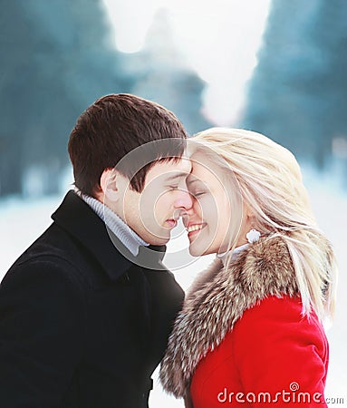 Beautiful happy sensual couple in love in cold sunny winter day Stock Photo