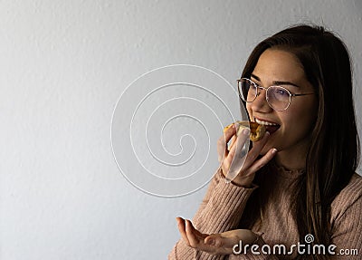 Beautiful and happy women portrait eating hamantash Purim apricot cookie Stock Photo