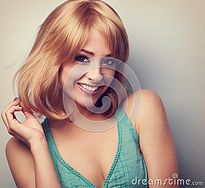Beautiful happy young woman with blond short bob hairstyle. Closeup toned portrait Stock Photo
