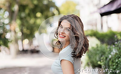 Beautiful happy young woman closeup outdoor portrait. Smiling model girl walking on a city street Stock Photo