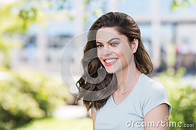 Beautiful happy young woman closeup portrait. Pretty model girl with perfect fresh clean skin smiling outdoors Stock Photo