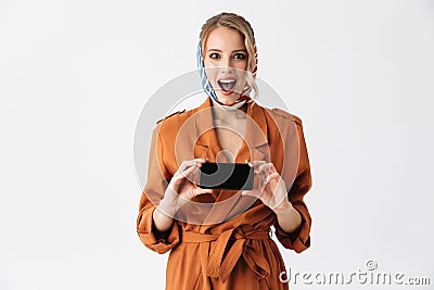 Beautiful happy young woman wearing silk scarf isolated over white background showing display of mobile phone Stock Photo