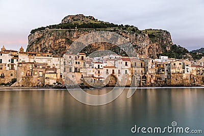 Beautiful harbor view of old houses in Cefalu at dusk, Sicily Stock Photo