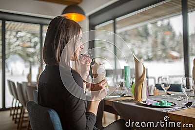 Beautiful healthy brunette woman drinking refreshing healthy drink Stock Photo