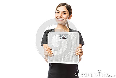 Beautiful Healthy Woman Smiling While Showing Weight Scale Stock Photo