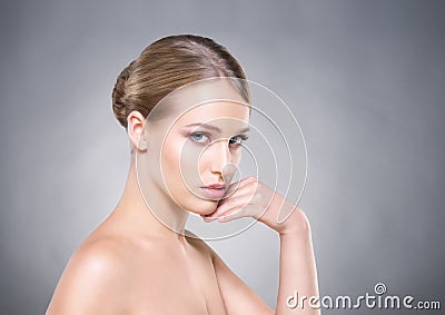 Beautiful healthy woman touching her cheek with her hand Stock Photo