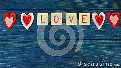 beautiful hearts red lettering love, on a blue wooden background Stock Photo