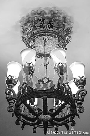 A beautiful heavy large metal wrought-iron lamp with white matte lampshades in the Moscow metro Stock Photo