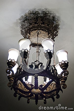 A beautiful heavy large metal wrought-iron lamp with white matte lampshades in the Moscow metro Stock Photo