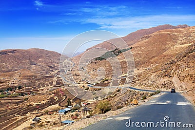 Beautiful highland valley landscape, scenery panoramic view, road and village in Drakensberg mountains, Lesotho, Southern Africa Stock Photo