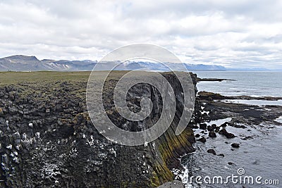 Hiking trail from Anarstapi to Hellnar with the raw ocean und big rocks and mountains in the west of Iceland at Snaefellsnes Penin Stock Photo