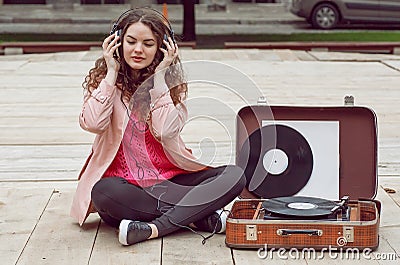 Beautiful hipster girl with old vintage vinyl records. Listen to music with emotions Stock Photo