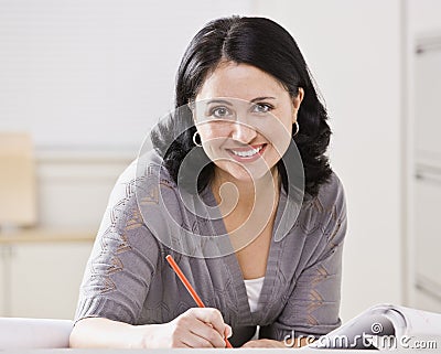 Beautiful Hispanic Woman Writing Stock Photo