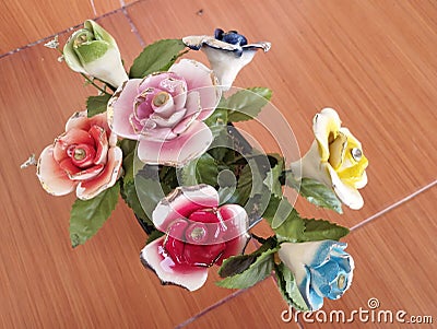 beautiful home accessories a flower replica made of ceramic (rose replica). brown floor as background Stock Photo