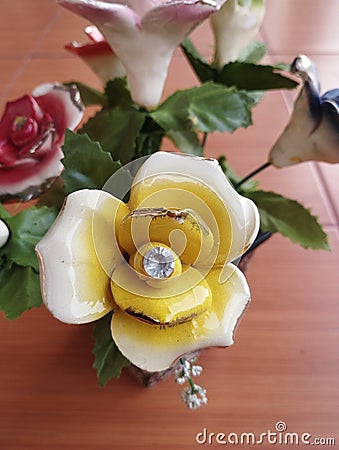 beautiful home accessories a flower replica made of ceramic (rose replica). brown floor as background Stock Photo