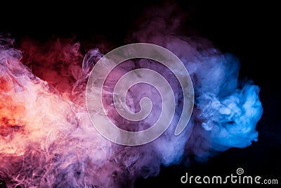 Beautiful horizontal column of smoke in the neon bright light of blue pink and orange on a black background exhaled out of the Stock Photo