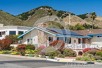 Beautiful houses with solar panels, with nicely landscaped front the yard, California Stock Photo