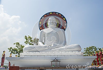 Beautiful huge white statue of Buddha on the roof of the temple in Colombo Stock Photo