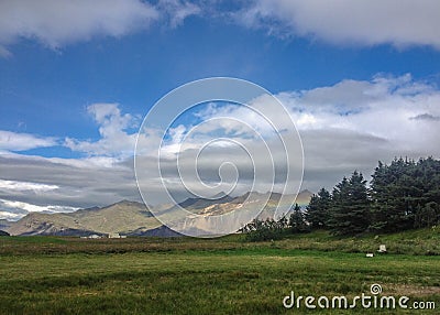 Beautiful Icelandic landscape with rainbow on mountains. Popular tourist destination in Hopf, south east Iceland, Europe Stock Photo