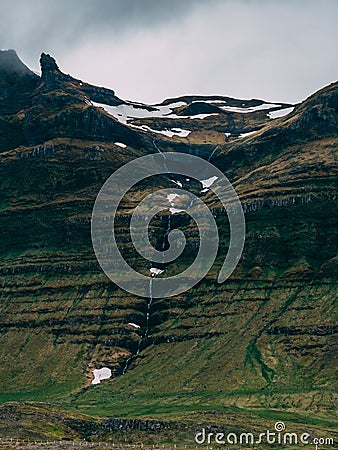 Beautiful icelandic scenery with glacier and grassland, covered in clouds picturesque Stock Photo