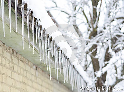 Beautiful icicles on the old asbestos roof in frosty winter Stock Photo