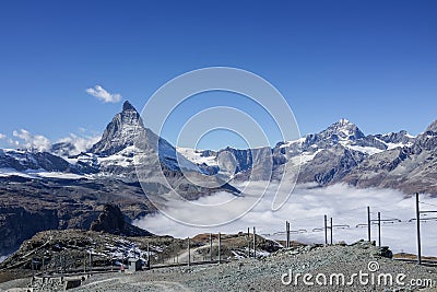 Beautiful iconic mountain Matterhorn with clear blue sky and mist below, Zermatt, Switzerland Stock Photo