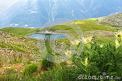 Beautiful idyllic Alps landscape with lake and mountains in summer Stock Photo