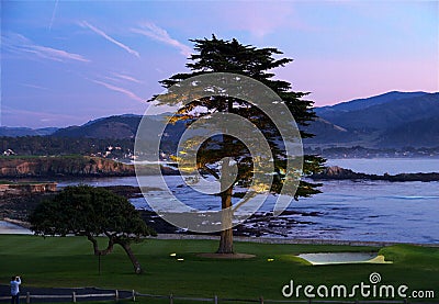 Beautiful illuminated golf course with ocean background Stock Photo