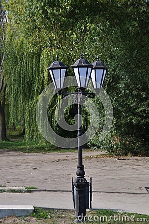 Lantern with three lamps in the city square Stock Photo