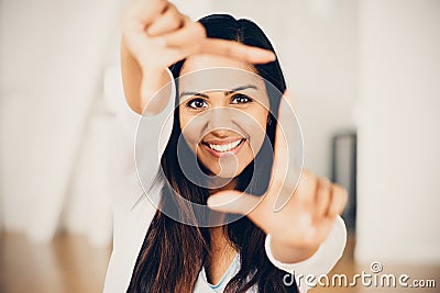 Beautiful Indian woman framing photograph happy smiling Stock Photo