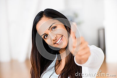 Beautiful Indian woman thumbs up happy smiling Stock Photo