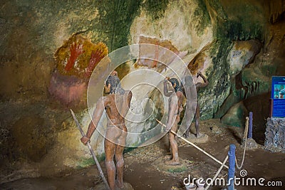 Beautiful indoor view of stoned caveman with spear in their hands inside of ancient cave Khao khanabnam in Krabi Editorial Stock Photo