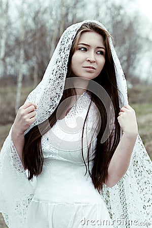 Beautiful innocent woman in white dress Stock Photo