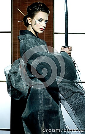 Beautiful japanese kimono woman with samurai sword Stock Photo