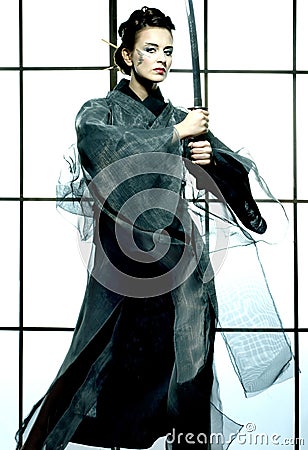 Beautiful japanese kimono woman with samurai sword Stock Photo