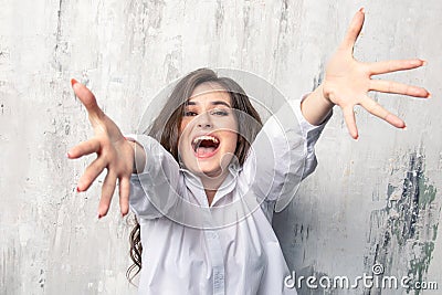 Beautiful joyful woman pulls her hands to the camera . I want hugs . Stock Photo