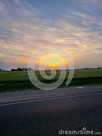 Beautiful Kansas Yellow Sunset and Road Stock Photo