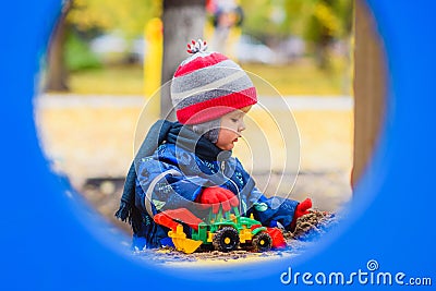 Child playing excavator on the street Stock Photo