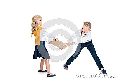 beautiful kids fighting for book Stock Photo