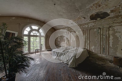 King Master Bed with Arched Windows & Hardwood Floors - Abandoned Mansion Stock Photo