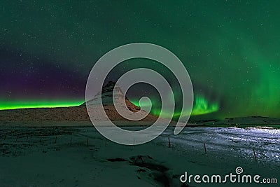 Beautiful Kirkjufell Mountain with Northern Lights Iceland Stock Photo