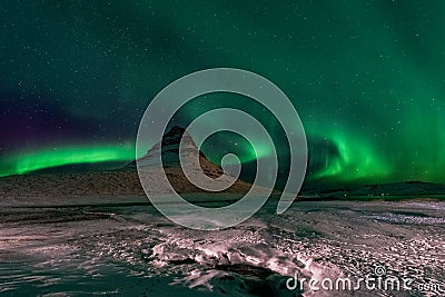 Beautiful Kirkjufell Mountain with Northern Lights Iceland Stock Photo